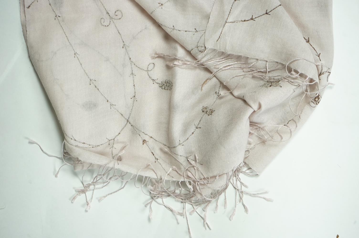 An Indian green and gold silk hand woven brocade stole, a cream pashmina embroidered stole and a similar finely woven and embroidered lilac stole (3). Brocade stole 38cm x 180cm., Condition - light stain to finely woven